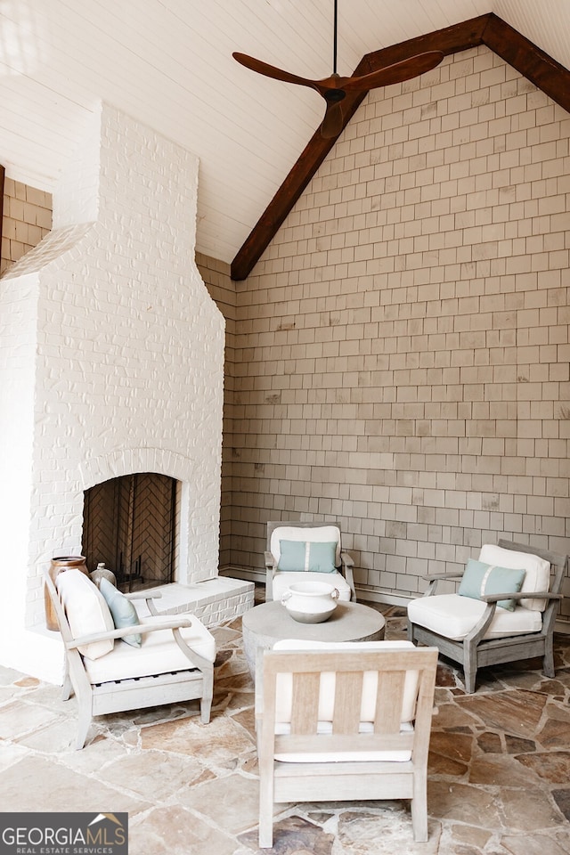 view of patio / terrace with a fireplace and ceiling fan