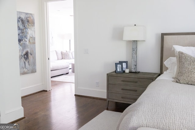 bedroom with dark hardwood / wood-style floors