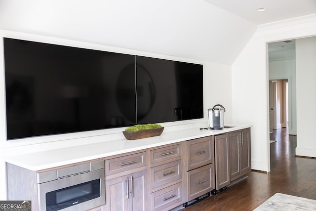 interior space featuring hardwood / wood-style flooring, vanity, and lofted ceiling