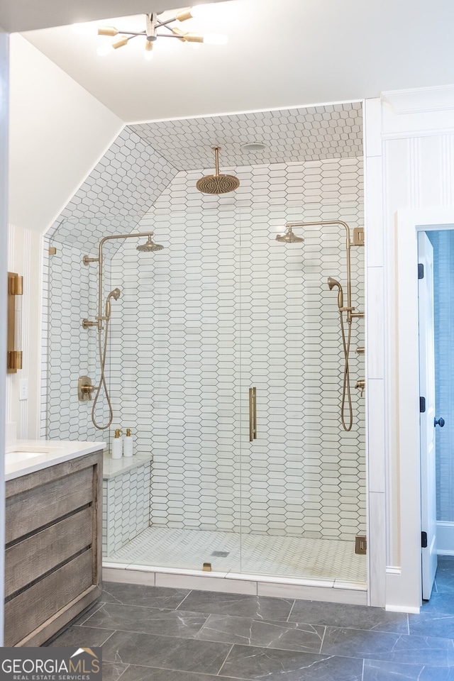 bathroom featuring walk in shower and vanity