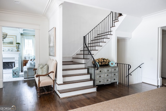 stairway featuring hardwood / wood-style flooring and ornamental molding