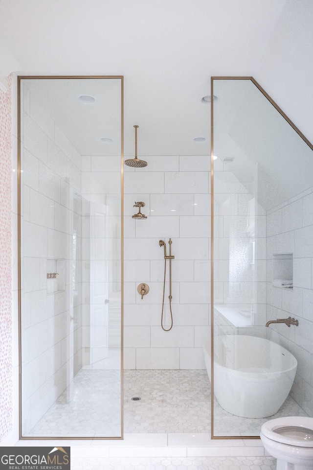 bathroom featuring toilet and a tile shower