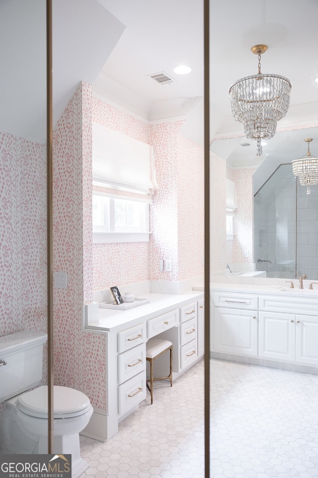 bathroom featuring vanity, a chandelier, and toilet