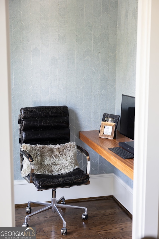 home office featuring wood-type flooring and built in desk