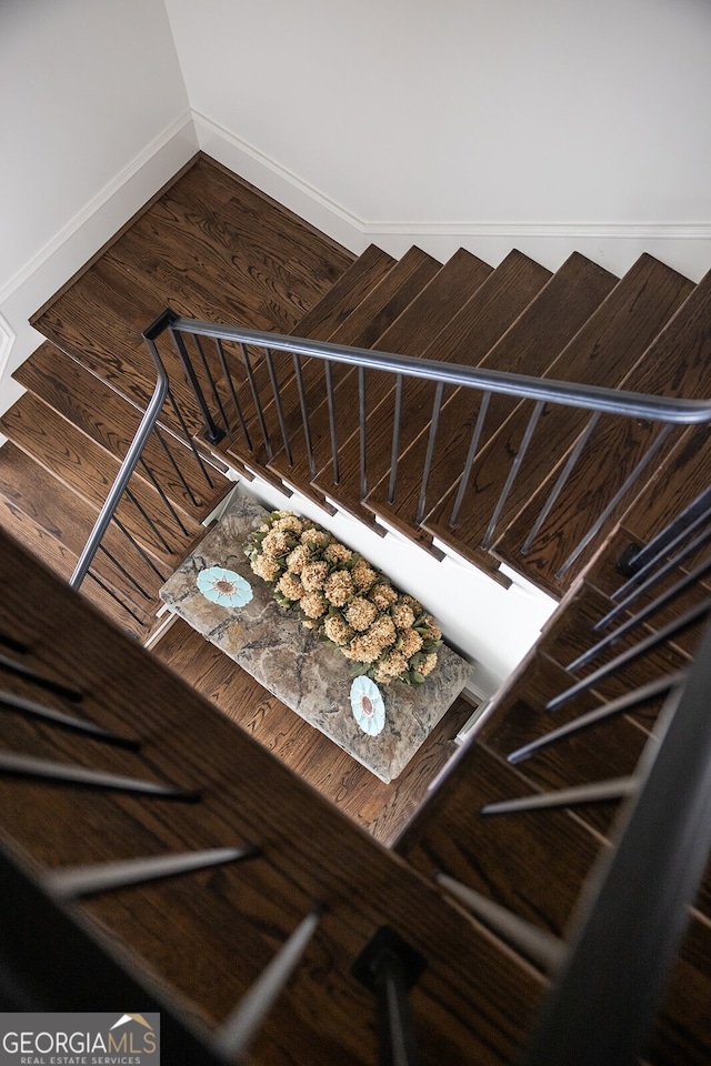 staircase featuring wood-type flooring