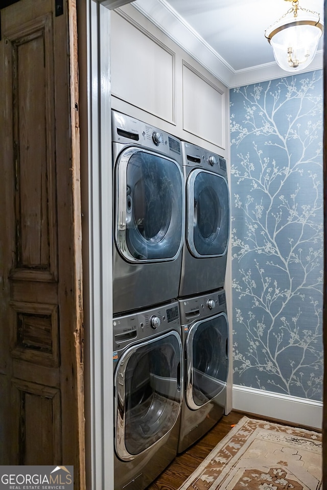 washroom with hardwood / wood-style flooring, stacked washing maching and dryer, cabinets, ornamental molding, and separate washer and dryer