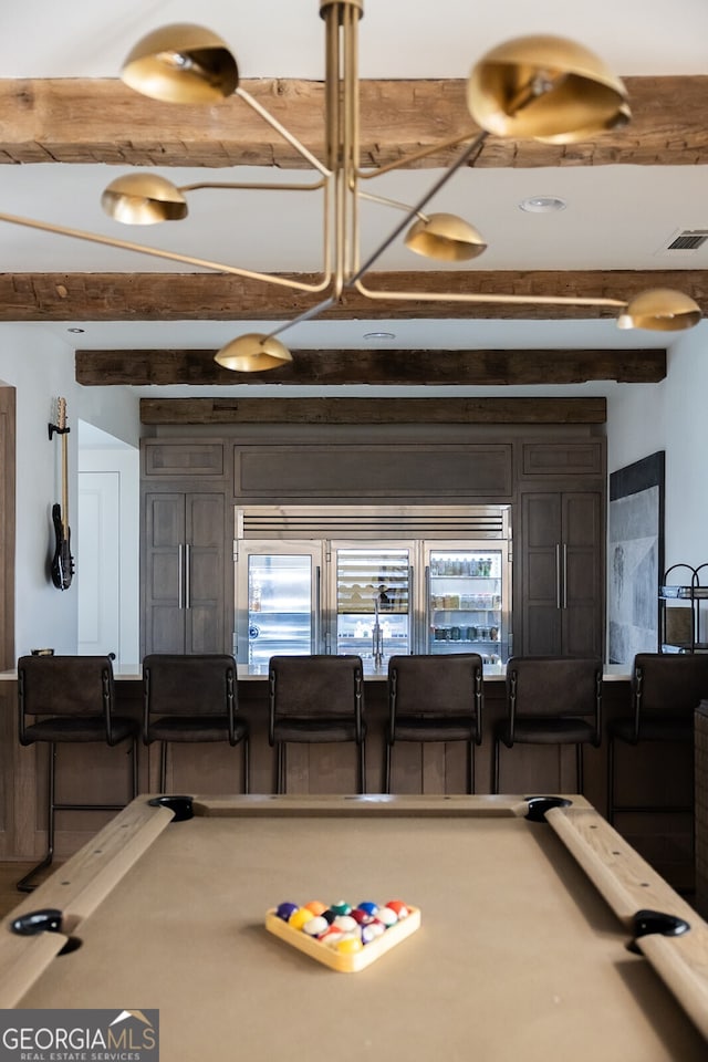 game room with pool table and beam ceiling