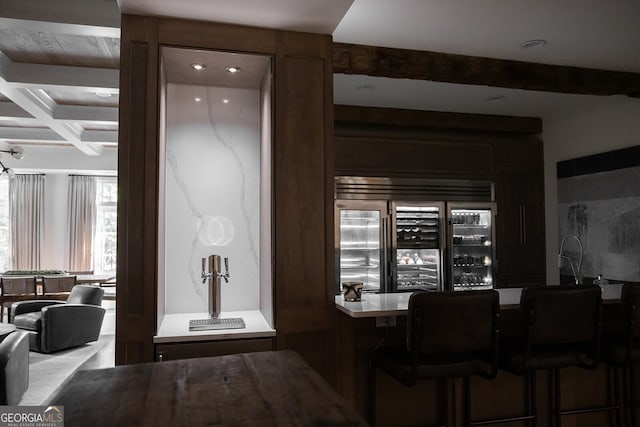 bar with coffered ceiling, beverage cooler, and beamed ceiling