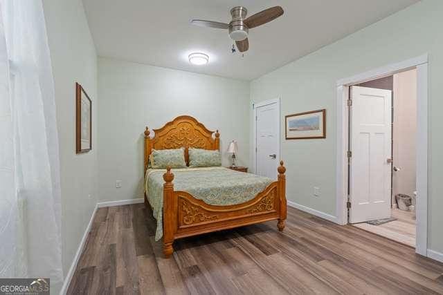 bedroom featuring ceiling fan and wood-type flooring