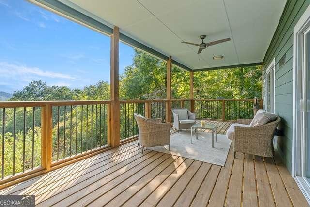 unfurnished sunroom featuring ceiling fan and plenty of natural light