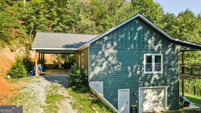 view of property exterior featuring a garage and a deck