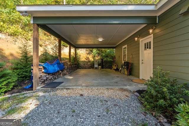 view of parking / parking lot featuring a carport