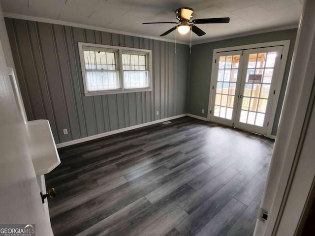 unfurnished room featuring ceiling fan, dark hardwood / wood-style floors, ornamental molding, and french doors