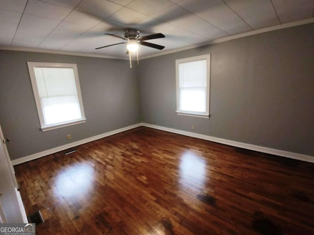 empty room featuring ceiling fan, dark hardwood / wood-style flooring, and ornamental molding