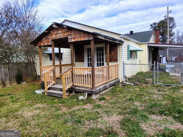 bungalow-style house with a front yard and a deck