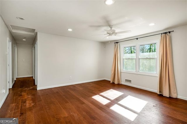 spare room featuring ceiling fan and dark hardwood / wood-style flooring