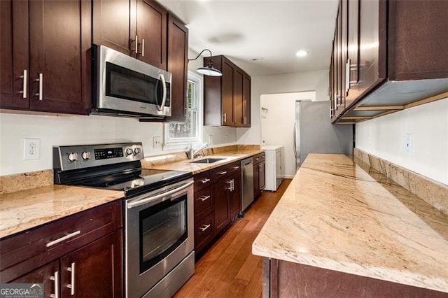 kitchen with light stone counters, stainless steel appliances, dark wood-type flooring, and sink