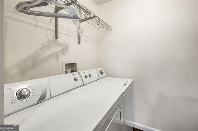 clothes washing area featuring separate washer and dryer