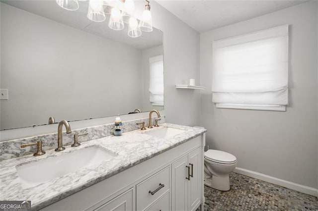 bathroom featuring toilet and vanity