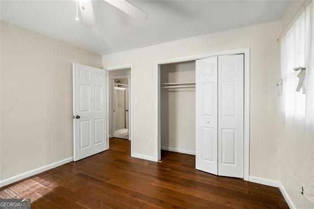 unfurnished bedroom featuring ceiling fan, a closet, and dark hardwood / wood-style floors