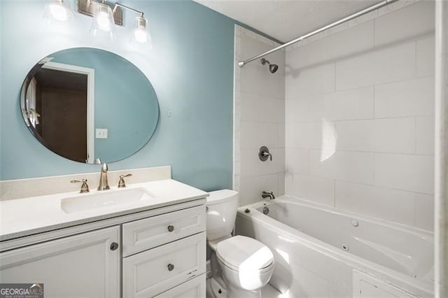 full bathroom with toilet, vanity, and tiled shower / bath