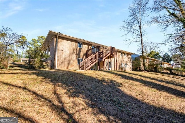 rear view of property featuring a lawn