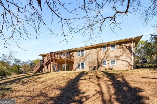 back of house with a yard and a deck