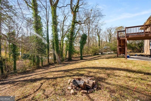 view of yard with a fire pit and a wooden deck