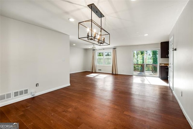 interior space with a chandelier and wood-type flooring