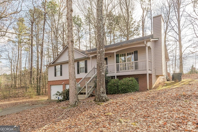 ranch-style house featuring a garage and covered porch