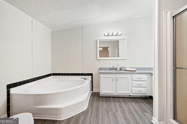 bathroom with a textured ceiling, wood-type flooring, vanity, crown molding, and plus walk in shower