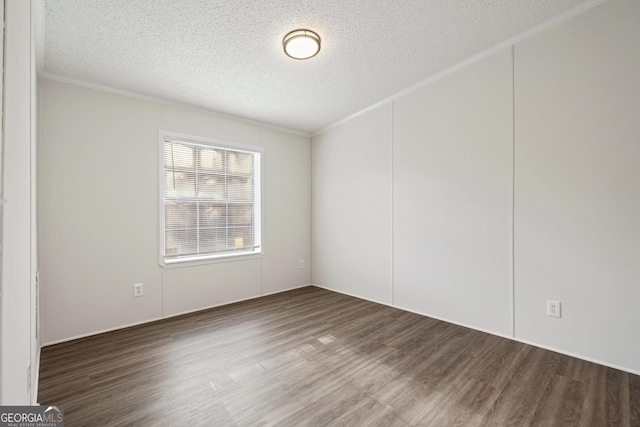 unfurnished room with a textured ceiling, ornamental molding, and dark hardwood / wood-style floors