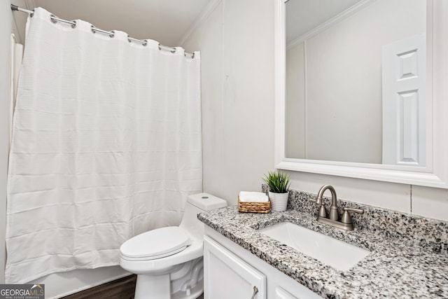 bathroom with walk in shower, crown molding, vanity, and toilet