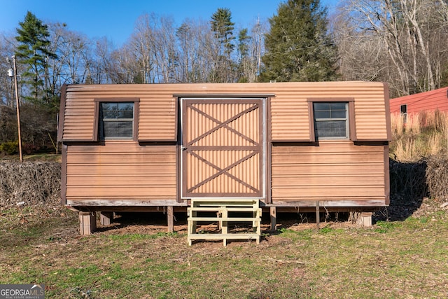 view of outbuilding with a yard