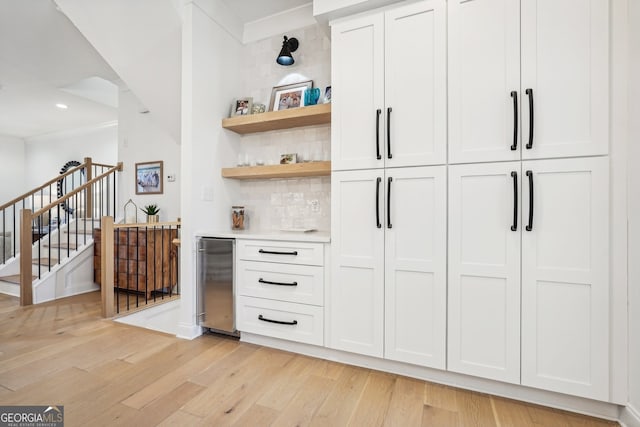 475 Rose Garden Ln, Alpharetta, GA 30009 - indoor dry bar featuring light wood finished floors, refrigerator, tasteful backsplash, stairway, and recessed lighting