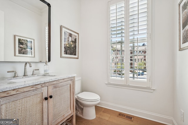 475 Rose Garden Ln, Alpharetta, GA 30009 - half bath featuring wood finished floors, vanity, and crown molding