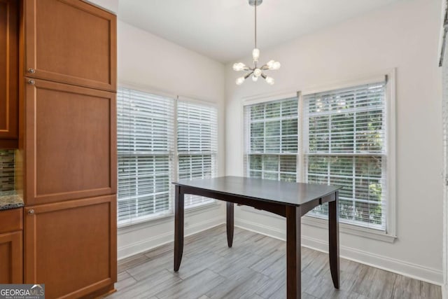 50 Biscayne Dr Unit 2109, Atlanta, GA 30309 - dining space featuring a chandelier, baseboards, and light wood-type flooring