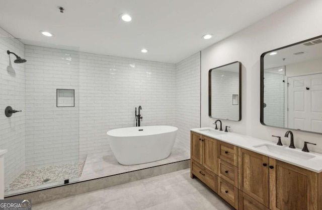 bathroom featuring vanity and shower with separate bathtub