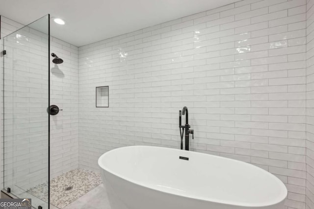 50 Biscayne Dr Unit 2109, Atlanta, GA 30309 - bathroom with a stall shower, a soaking tub, tile walls, and recessed lighting