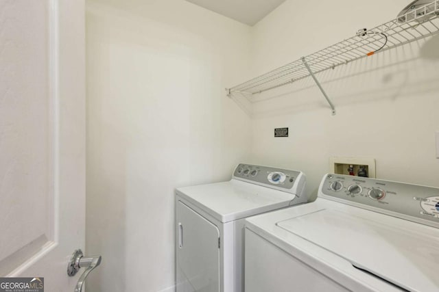 clothes washing area featuring washer and clothes dryer