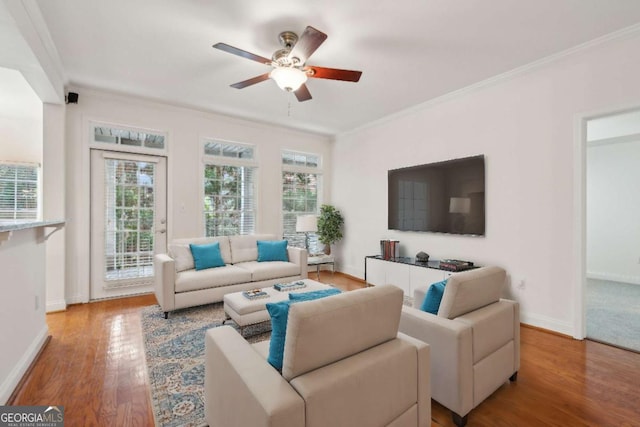 living room featuring crown molding, hardwood / wood-style floors, and ceiling fan