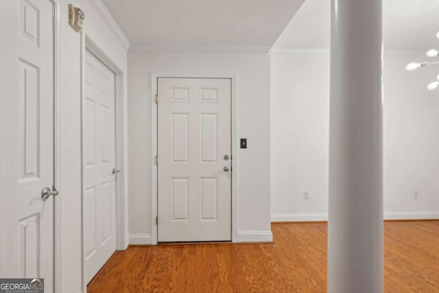 entryway with light wood-type flooring and ornamental molding