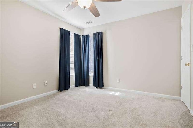 carpeted empty room featuring ceiling fan