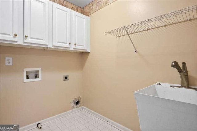 washroom featuring hookup for a washing machine, sink, cabinets, and hookup for an electric dryer