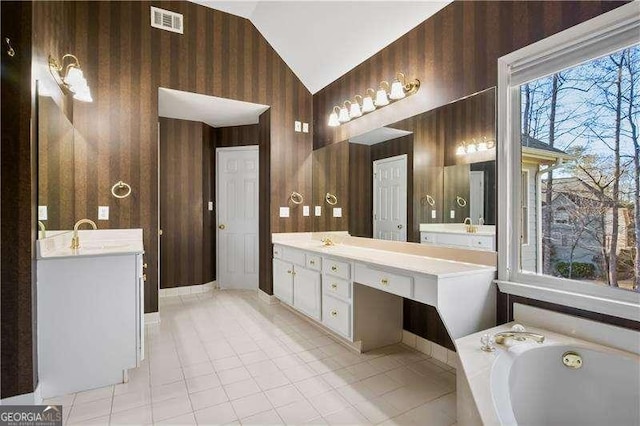 bathroom with a bath, vanity, lofted ceiling, and wood walls