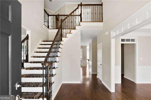 foyer featuring dark hardwood / wood-style flooring and crown molding