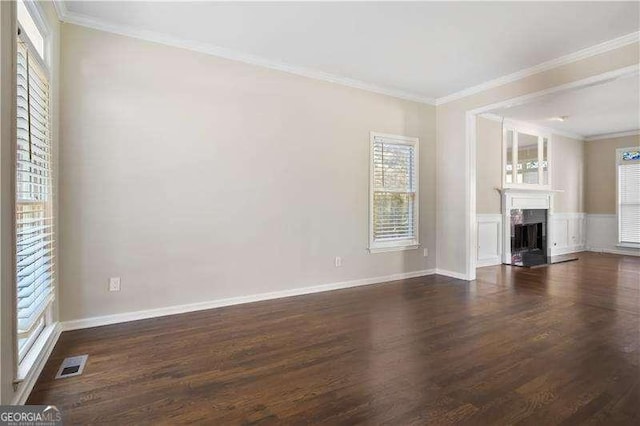 unfurnished living room with dark hardwood / wood-style floors and crown molding