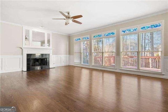 unfurnished living room with ceiling fan, dark hardwood / wood-style floors, and crown molding