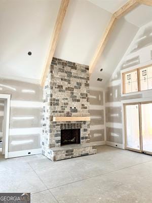 unfurnished living room with concrete floors, a fireplace, plenty of natural light, and high vaulted ceiling