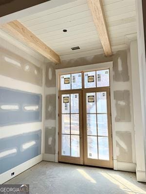 entryway featuring wood ceiling, french doors, concrete floors, and beamed ceiling